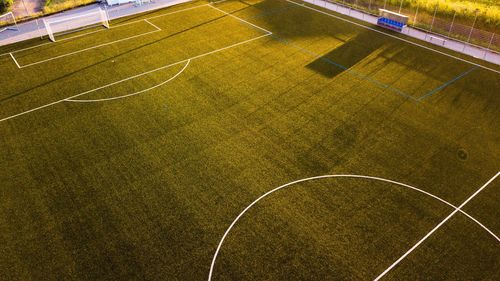 High angle view of empty soccer field during sunset