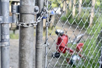 Close-up of chainlink fence against blurred background