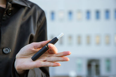 Midsection of man using mobile phone