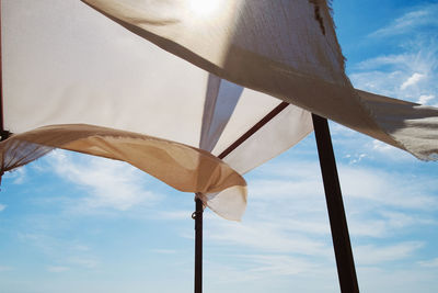 Low angle view of flags against sky