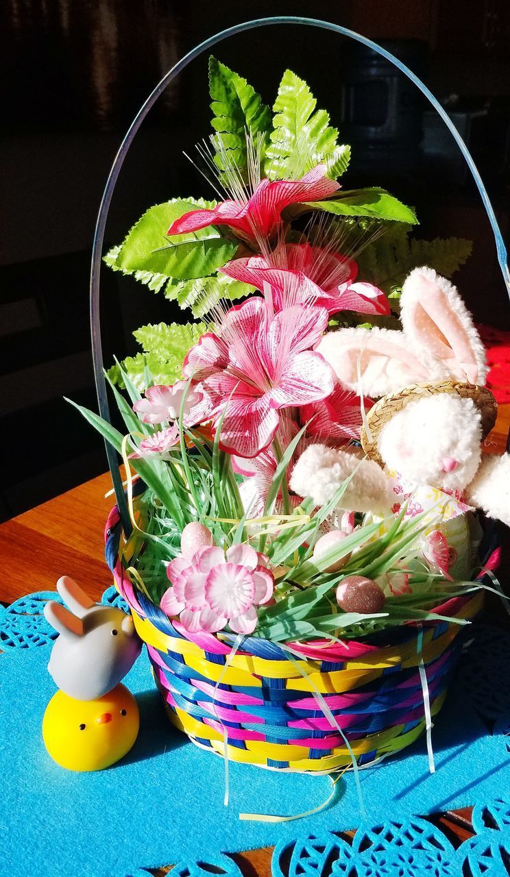 HIGH ANGLE VIEW OF PINK FLOWERS IN BASKET ON TABLE