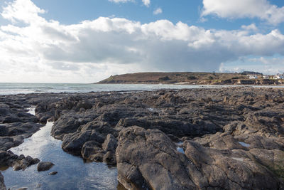 Rocks on beach against sky