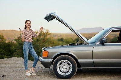 Side view of man holding car