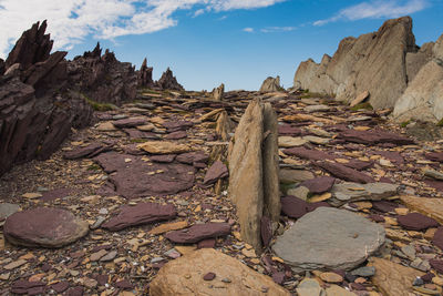 Colorful geologic rock formations on sea shore 