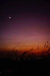 Scenic view of silhouette landscape against sky at night