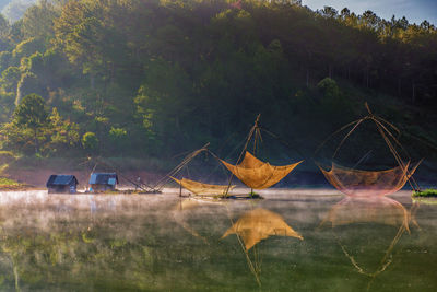 Fishing nets on lake against mountain