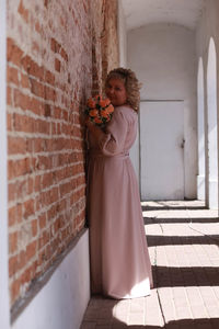 Woman standing against wall