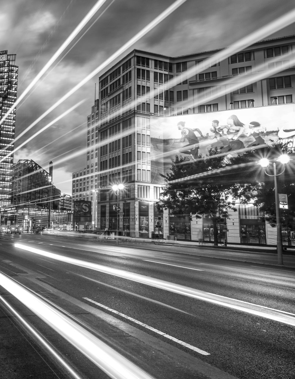 LIGHT TRAILS ON ROAD ALONG BUILDINGS