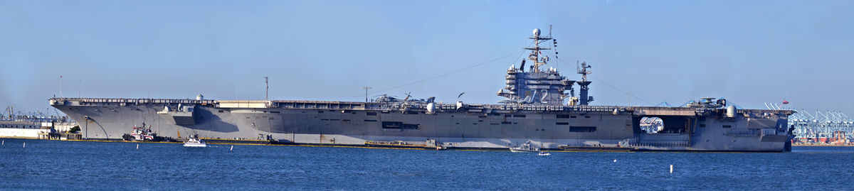 View of harbor against clear blue sky