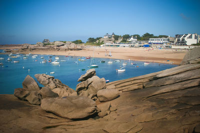 Scenic view of beach against clear blue sky