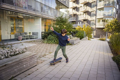 Boy skateboarding in residential area