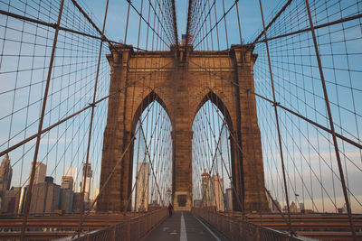 Low angle view of brooklyn bridge in city against sky