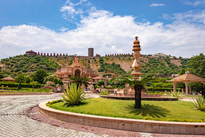 Artistic carved red stone jain temple with bright blue sky at morning from unique angle