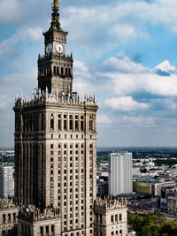 View of cityscape against cloudy sky