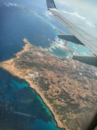 Cropped image of airplane flying over landscape