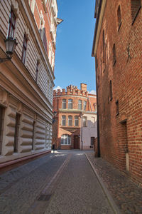 Street amidst buildings against sky