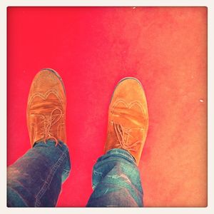 Low section of person standing on tiled floor