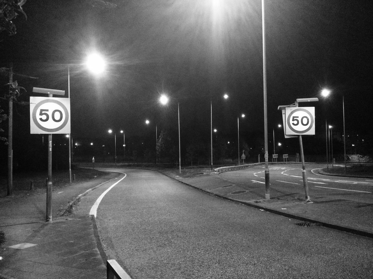 ROAD SIGN BY STREET AGAINST SKY