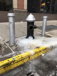 Yellow arrow symbol on street by building