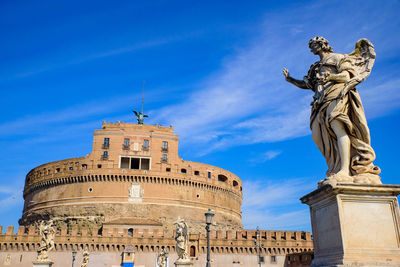 Low angle view of statue against blue sky