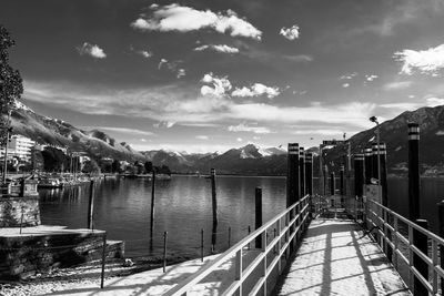 Scenic view of lake by city against sky