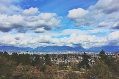 Scenic view of trees and mountains against sky