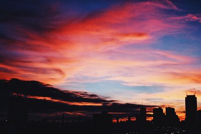 Silhouette cityscape against sky during sunset