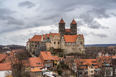 Buildings in town against sky