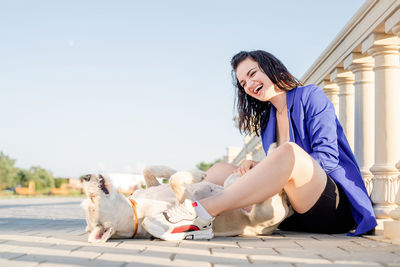 Woman with dog sitting outdoors