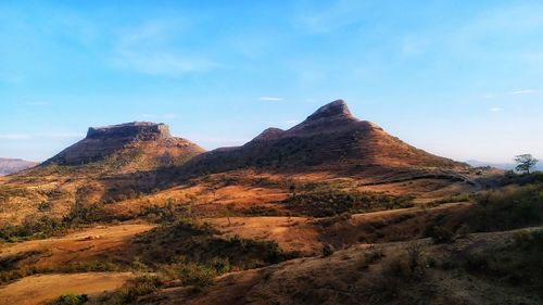 Scenic view of arid landscape against sky