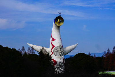 Low angle view of statue against blue sky