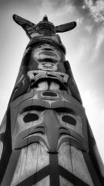 Low angle view of totem pole against sky