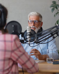 Man and woman talking during podcast