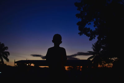 Silhouette man standing against sky during sunset