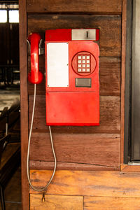 Red telephone booth on wall