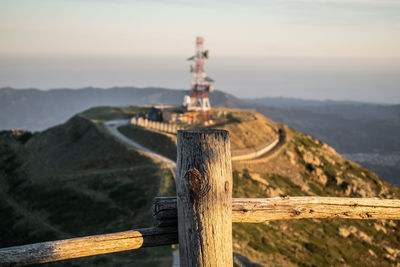 Tower amidst land against sky