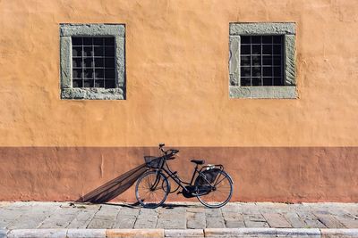 Bicycle leaning on wall