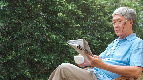 Side view of a man using mobile phone