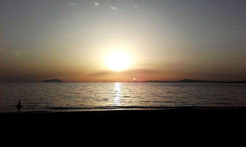 Scenic view of sea against sky at sunset