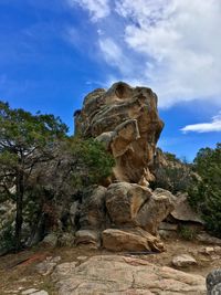 Low angle view of rocks on land against sky