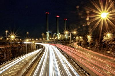 Light trails on road in city at night