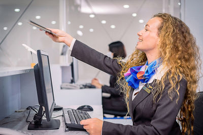 Side view of woman using mobile phone