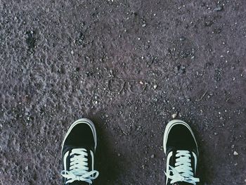 Low section of man standing on street
