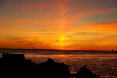 Scenic view of sea against sky during sunset