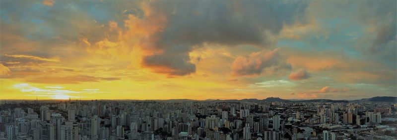 Panoramic shot of buildings against sky during sunset