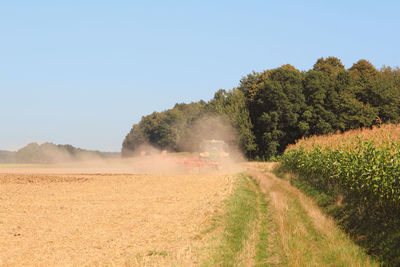 View of dirt road against clear sky