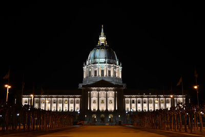 Illuminated building against sky at night