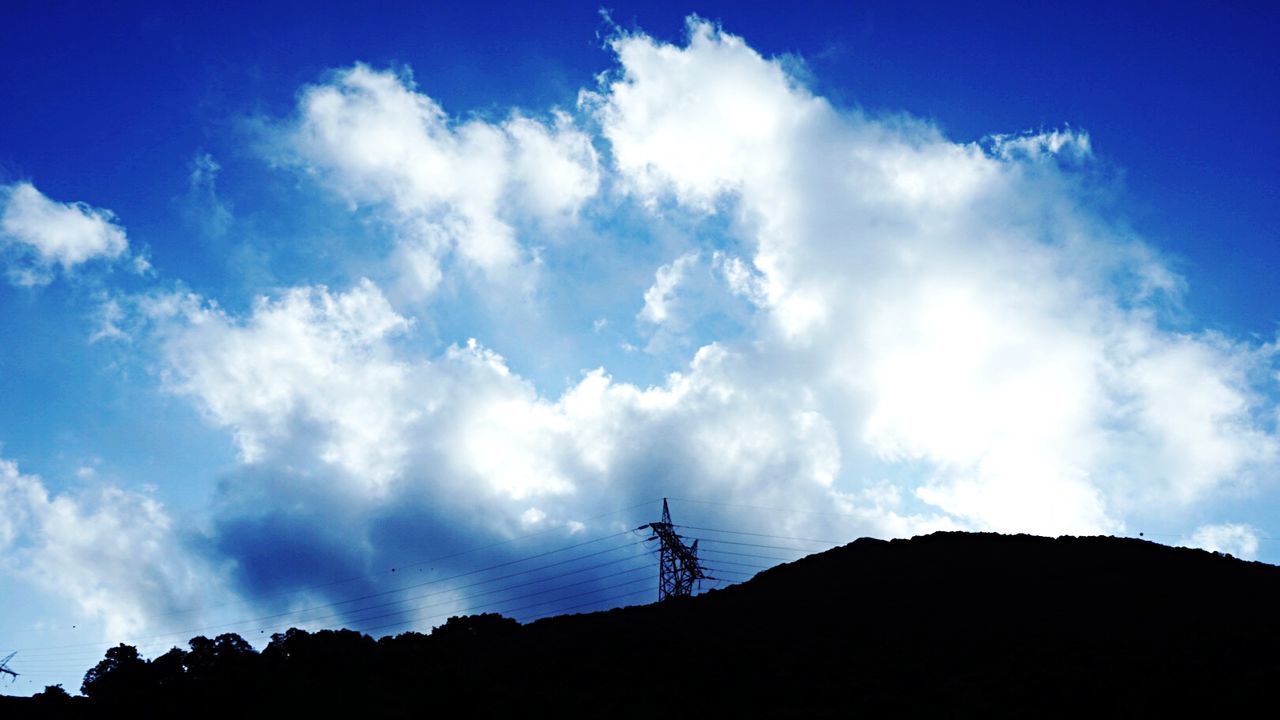 sky, low angle view, silhouette, cloud - sky, blue, cloud, electricity pylon, power line, built structure, cloudy, nature, connection, sunlight, fuel and power generation, electricity, technology, outdoors, architecture, day, cable