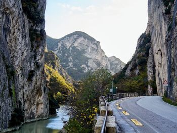 Scenic view of river amidst mountains against sky