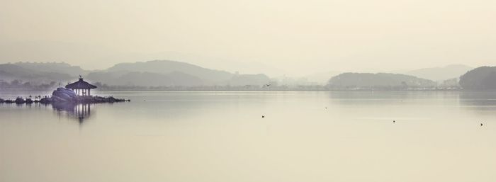 Scenic view of lake with mountains in background